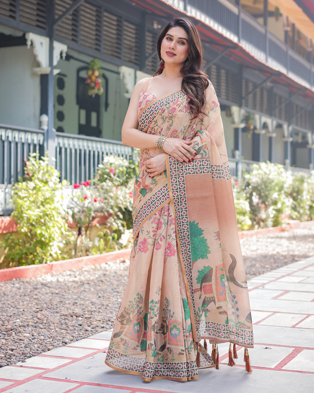 Elegant woman posing in a Mauve Pink Handloom Printed Saree with multi-color floral designs.