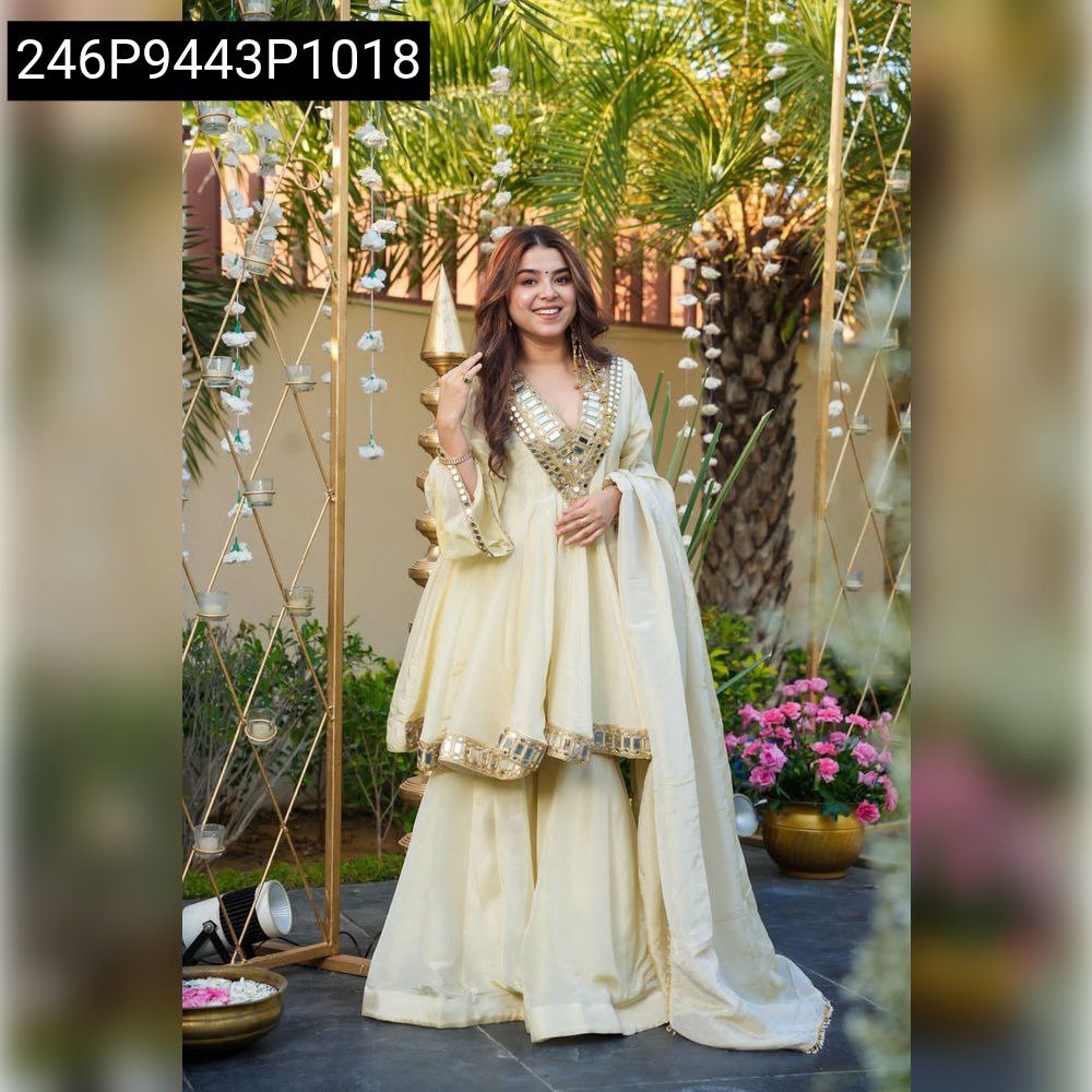 Full body shot of a woman gracefully posing in a Cream Chinon Anarkali Suit with matching dupatta, showcasing the complete outfit.