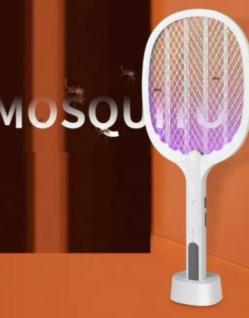 Blue electric mosquito killer racket held in hand outdoors