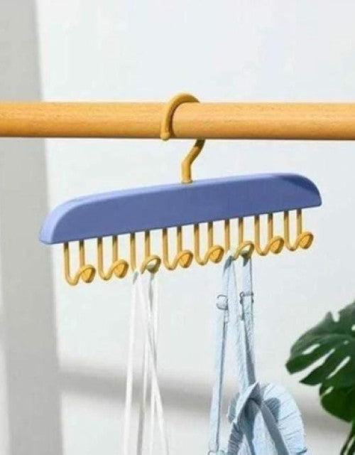 White multi-purpose 8 hooks hanger organizing coats, hats, and bags on a wall.