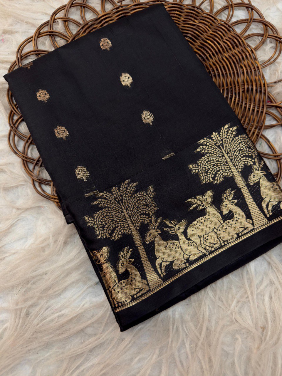TRENDBUY Black Mysore Silk Saree with golden deer motif border and butta work, top view.