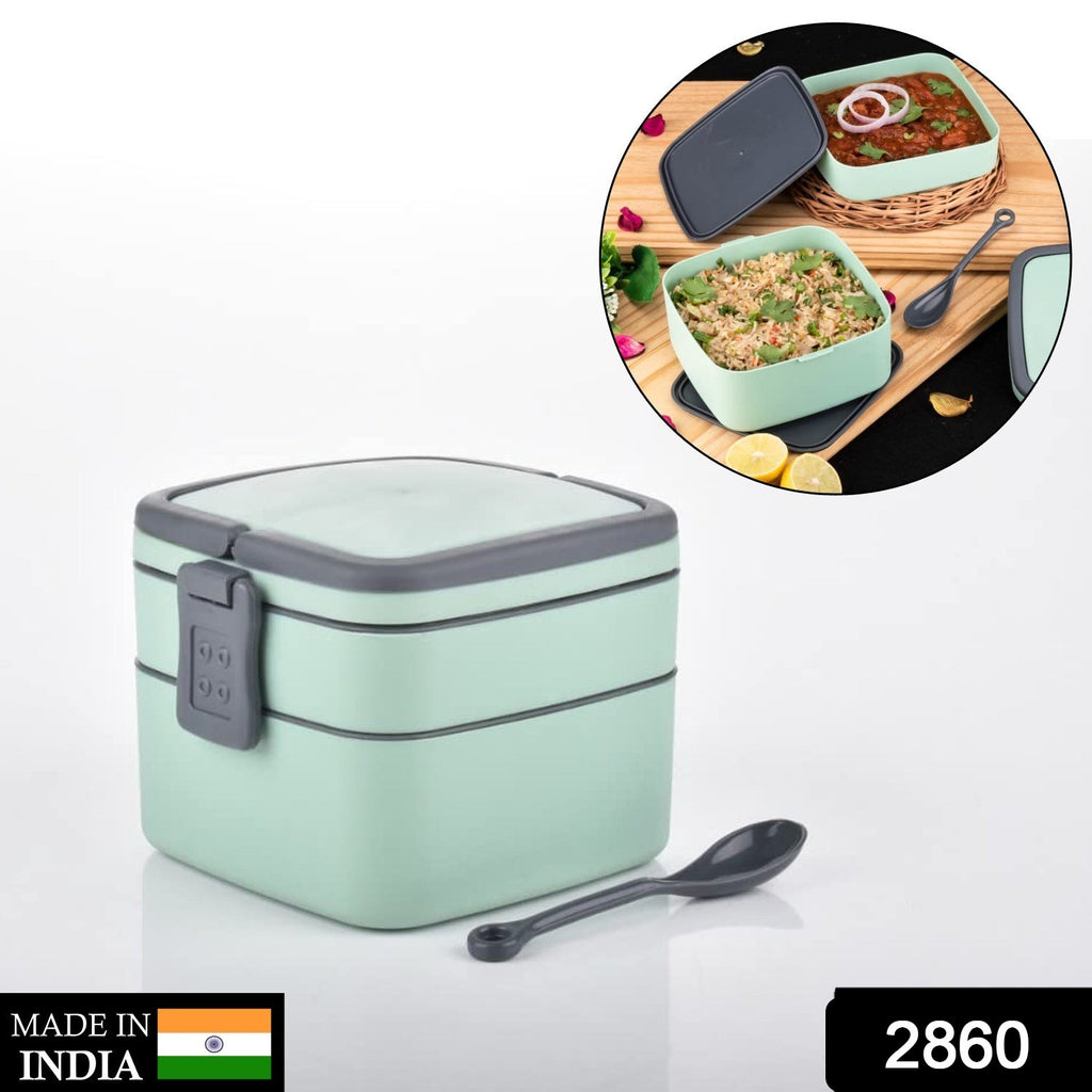 Green double-layer stackable portable lunch box with carrying handle and spoon.