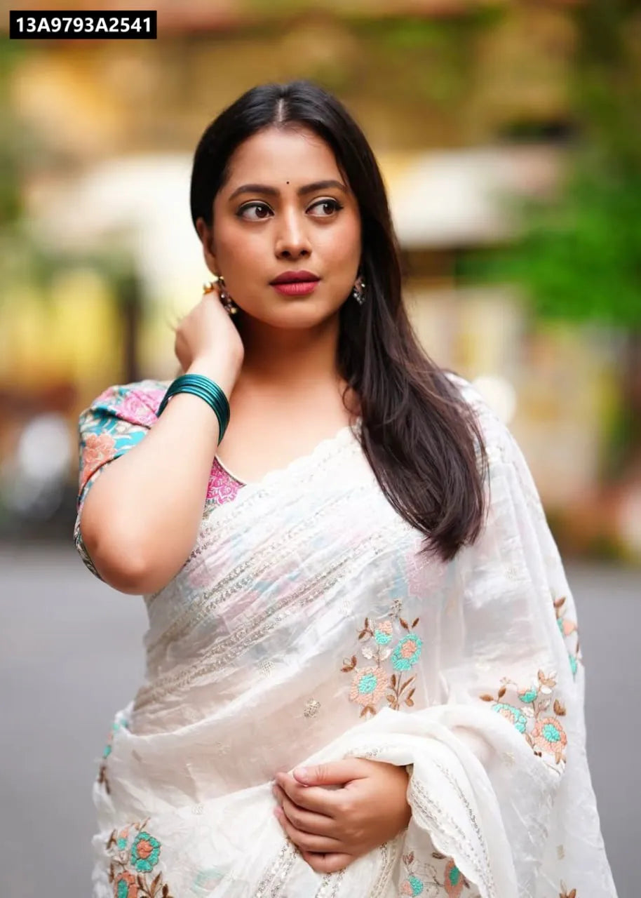Model wearing Off White Vanilla Paper Silk Saree with multicolor floral embroidery and crape silk printed blouse, 3/4 view.