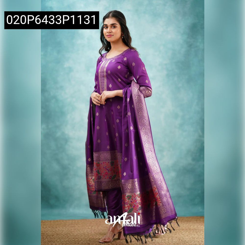 Full body shot of a woman in a complete purple Paithani silk salwar suit set, including kurti, pant, and intricately bordered dupatta.