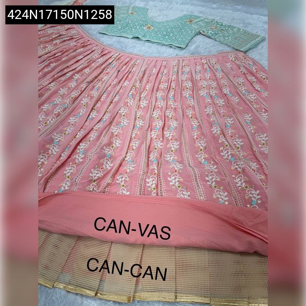Close-up of intricate gold and silver sequence embroidery on peach faux georgette fabric