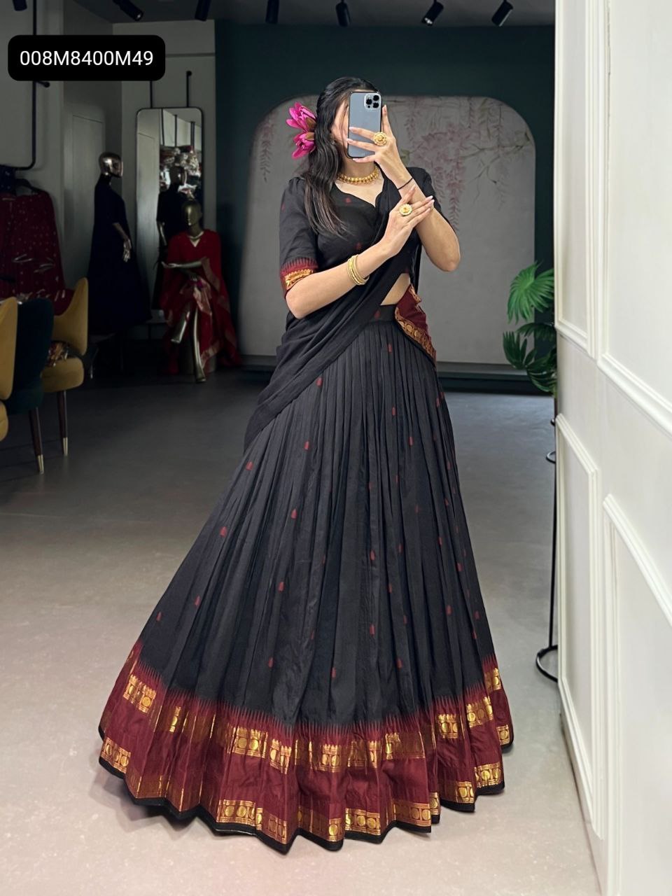 Full front view of a model wearing the TRENDBUY black Chanderi cotton half saree lehenga choli with a rich zari border, posing gracefully in an indoor setting.