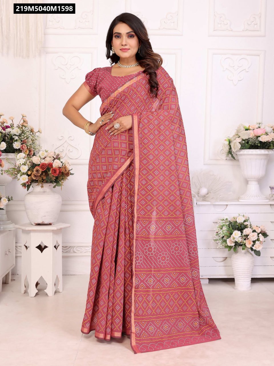 Woman wearing a pinkish-red Patola and Bandhej printed cotton saree with zari border