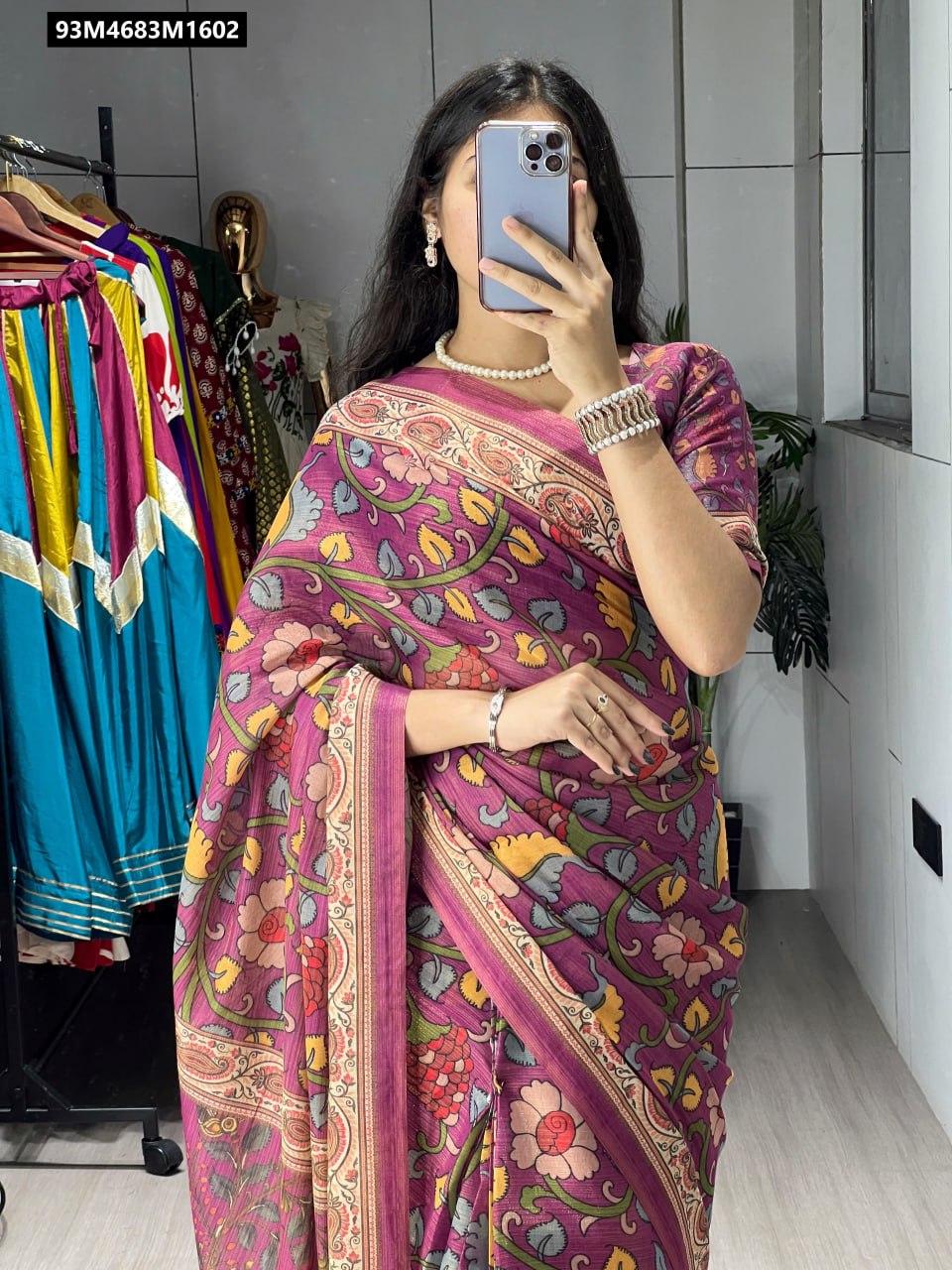 Woman in a purple all-over printed shimmer saree
