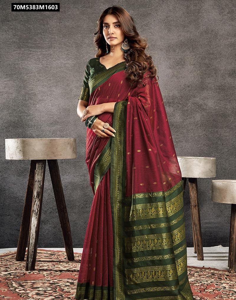 Model wearing a deep red Kalyani cotton silk saree with a dark green border and gold zari motifs.