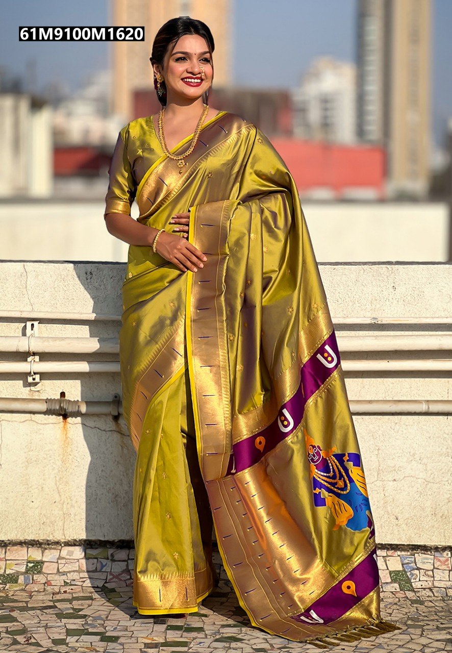 Woman in a golden-yellow soft silk Paithani saree with floral motifs and a purple Vitthala pallu.