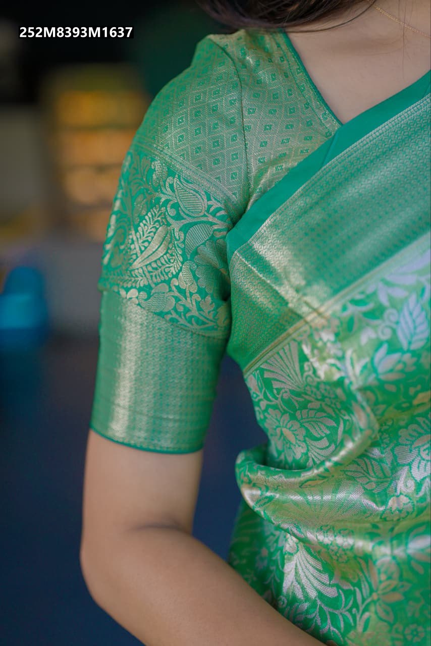 Model wearing a Mint Green Kanchipuram silk saree with intricate golden zari floral and paisley motifs, showcasing the detailed weave.