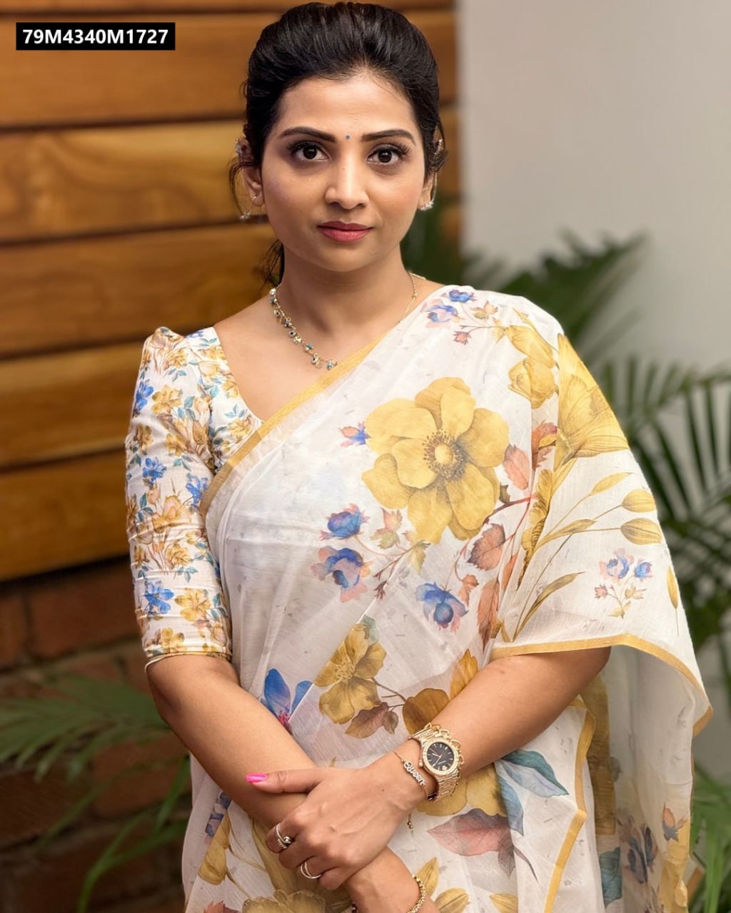 Woman modeling a white linen saree with yellow and blue floral digital print, paired with a matching floral slub silk blouse.