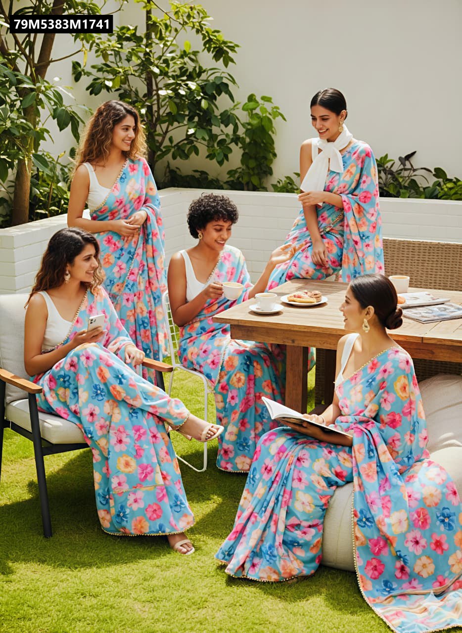 Five women in TRENDBUY aqua blue floral digital print sarees with white blouses, socializing in a bright garden setting.