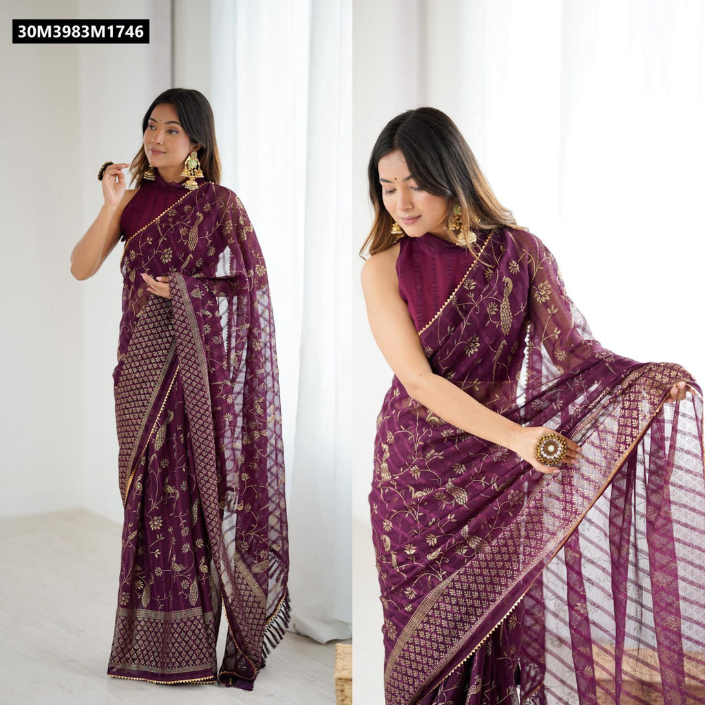 Model in a deep plum TRENDBUY georgette silk saree with intricate gold foil peacock and floral patterns, featuring a delicate border and zalar lace, paired with a matching halter-neck blouse.