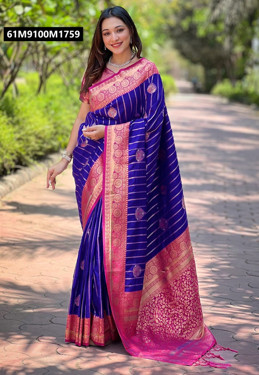 A woman smiling, elegantly draped in a TRENDBUY Royal Blue Soft Silk Saree with a rich pink zari border and pallu, showcasing rose gold motifs.