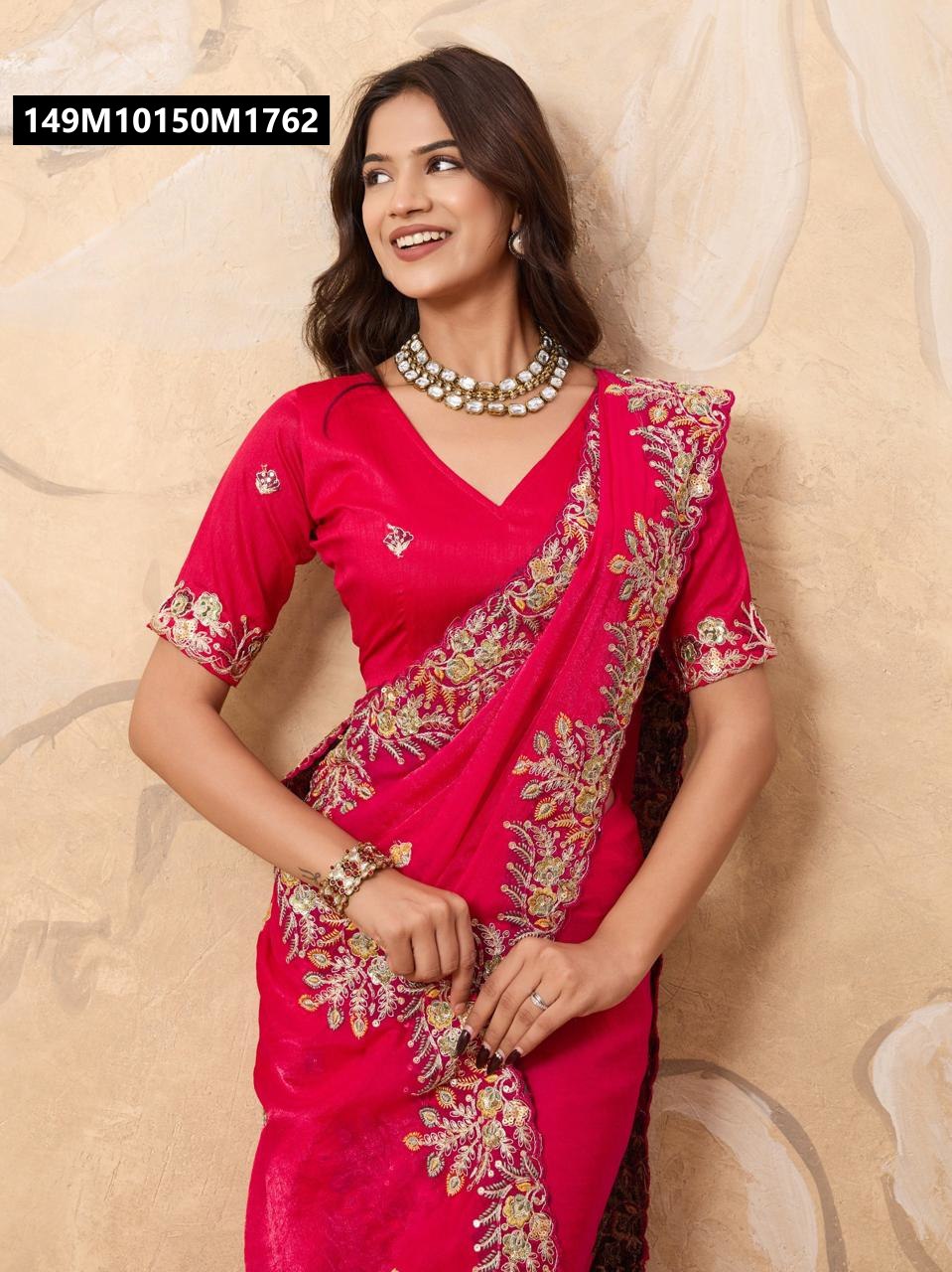 Model gracefully posing in a vibrant Rani Pink TRENDBUY embroidered Soft Fendy Chiffon Saree with matching blouse and elegant jewelry.