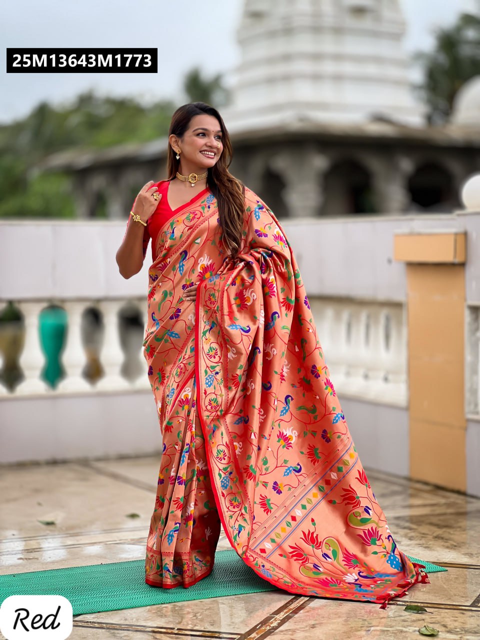 Model gracefully posing in a vibrant Red Pethani Silk Saree by TRENDBUY, featuring intricate Meenakari peacock and lotus motifs, paired with a matching red blouse.