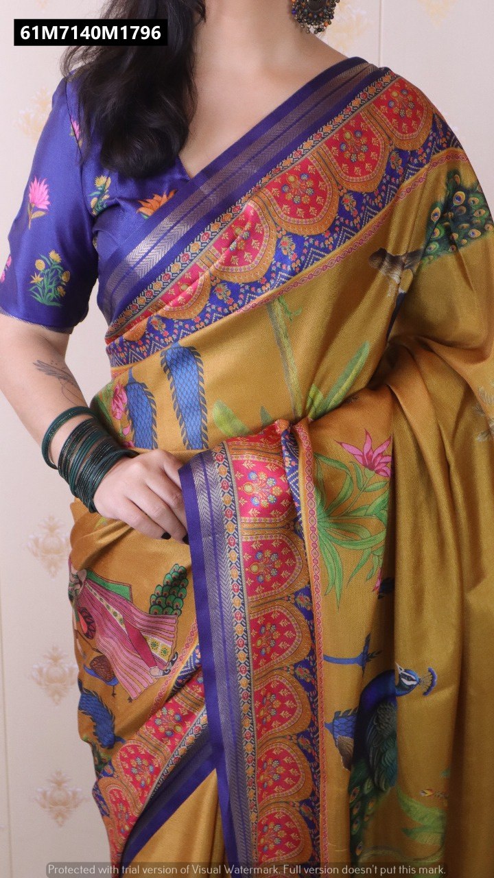 Close-up of TRENDBUY Mustard Yellow Tussar Silk Saree, highlighting intricate Pichwai prints, peacock motif, and blue zari woven border, with hands visible.