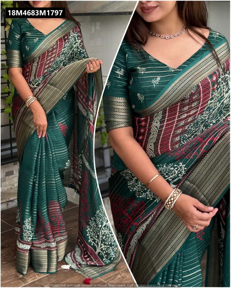 A woman elegantly draped in a dark teal TRENDBUY Pure Zari Moss saree, featuring a v-neck blouse, intricate geometric and tree-branch patterns in red, white, and gold, and a prominent zari jacquard border, posing indoors.