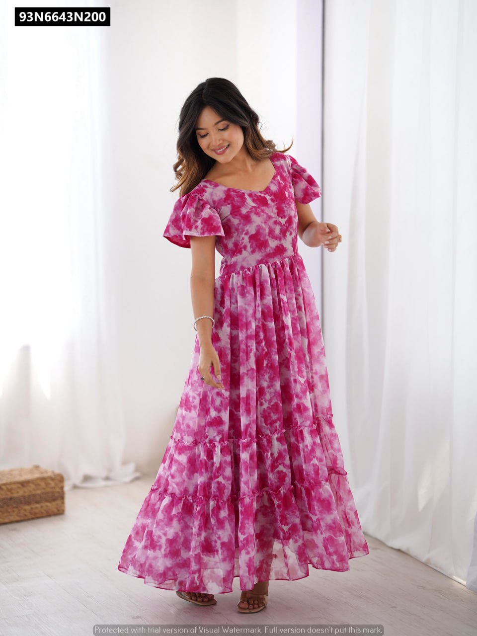 TRENDBUY women's long pink faux georgette kurti with all over tie-dye print and double frill patterns, styled by a model in a vibrant full-body pose.