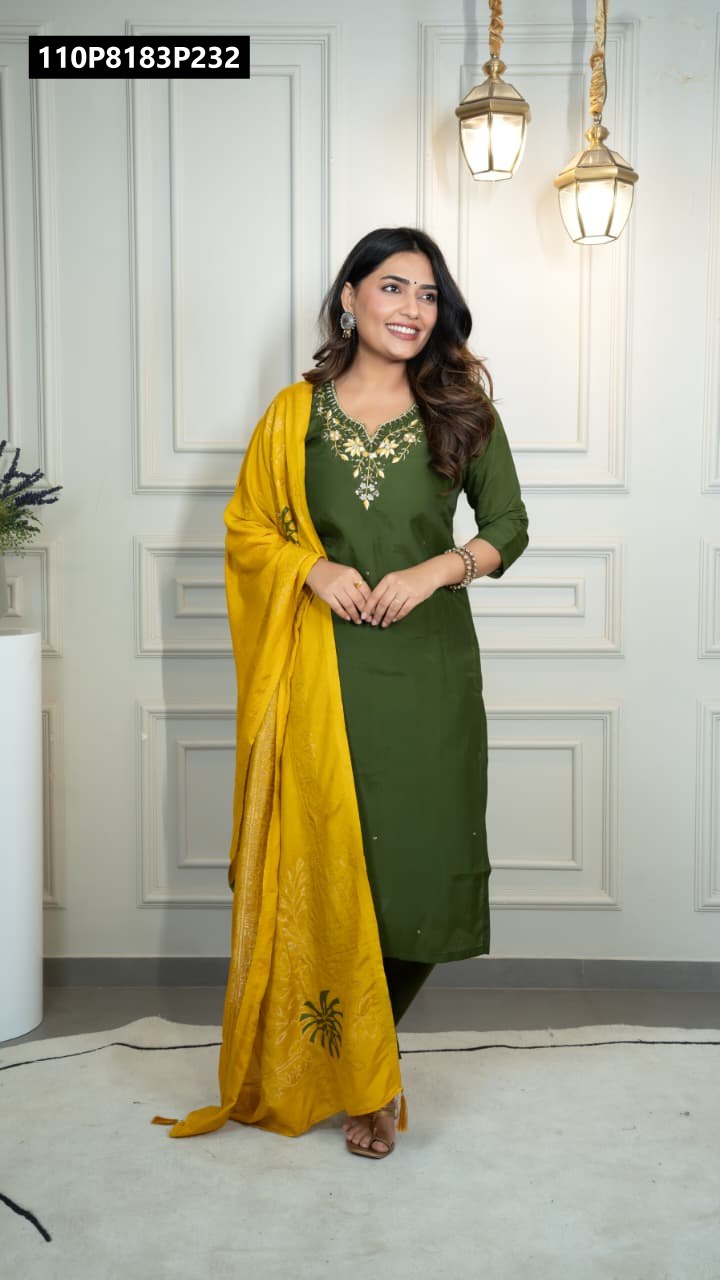 Model smiling, posing in full Mahendi Roman silk kurta set with yellow jacquard dupatta, front view.