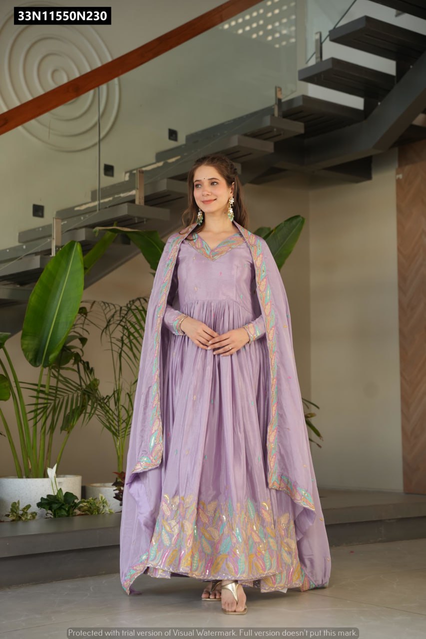Front view of TRENDBUY Lavender Chinnon Gown with full sleeves, V-neck, and intricate sequins and thread embroidery on the skirt and dupatta, worn by a smiling model.