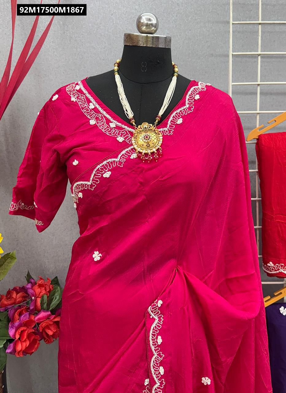 Close-up of a mannequin wearing a vibrant fuchsia Pure Upada Silk saree, featuring intricate white hand-worked Khatli embroidery along the v-neck blouse and pallu border, adorned with a statement gold necklace.