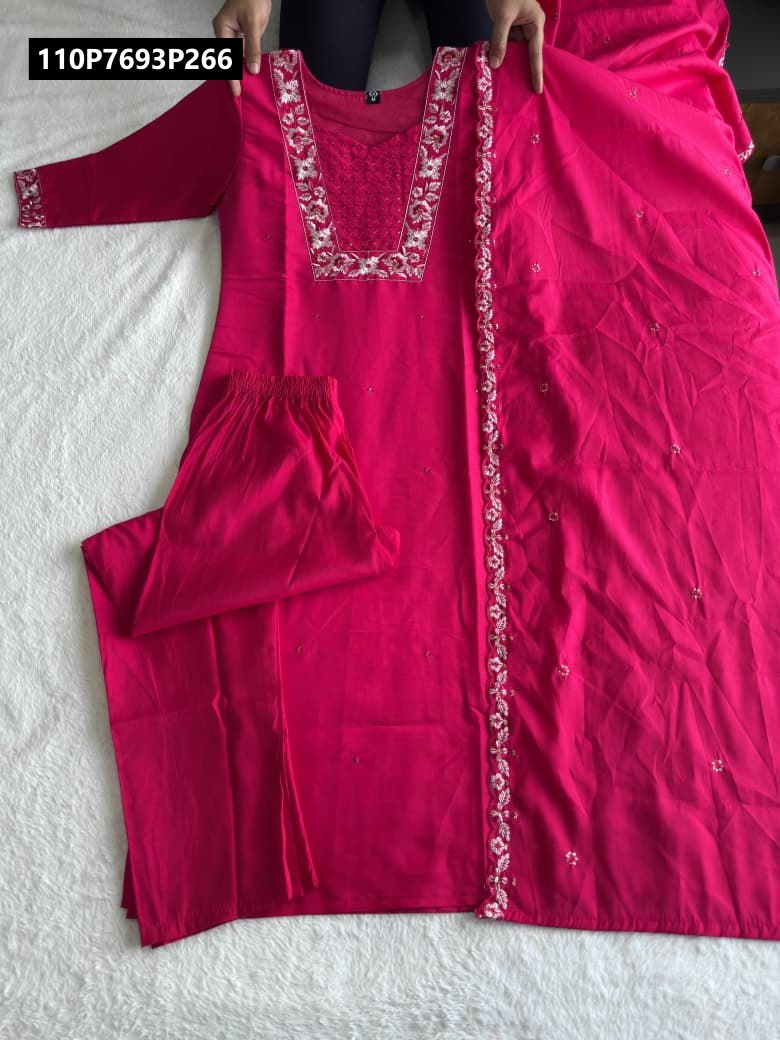 Full-length shot of a Pink (fuchsia) Roman silk embroidered kurti with long sleeves, matching gathered pants, and a wide embroidered dupatta, carefully laid out on a white surface.