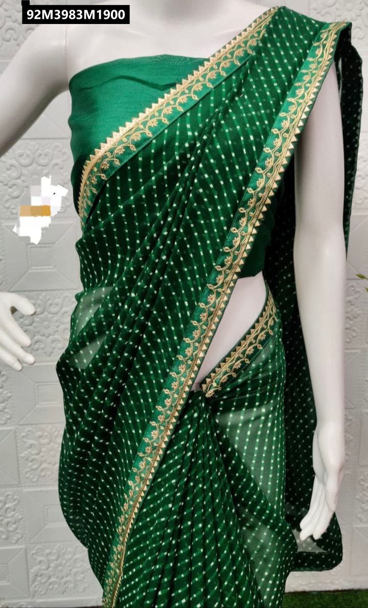 A stunning dark green Georgette Lehariya saree with delicate gold Gota borders, draped elegantly on a mannequin, showcasing its fluid fabric and intricate pattern.