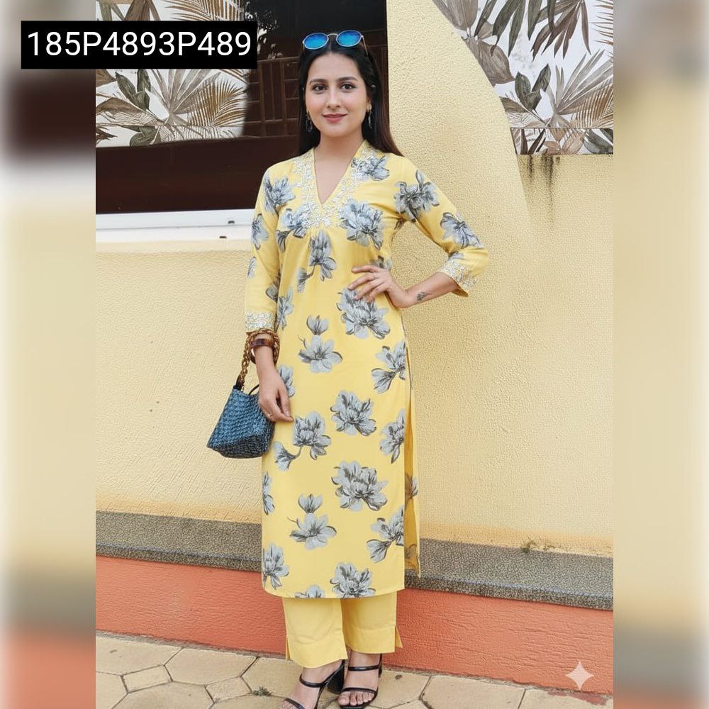 TRENDBUY woman wearing yellow floral faux georgette kurta set with palazzo pants and white embroidered V-neck.