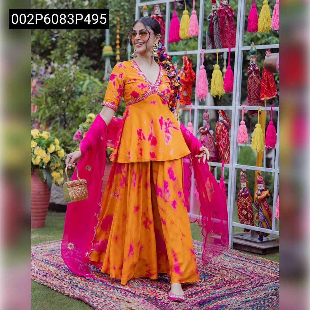 Model smiling and walking in a full body shot, showcasing the flowing silhouette of the orange and hot pink French crepe kurta with palazzo and dupatta.