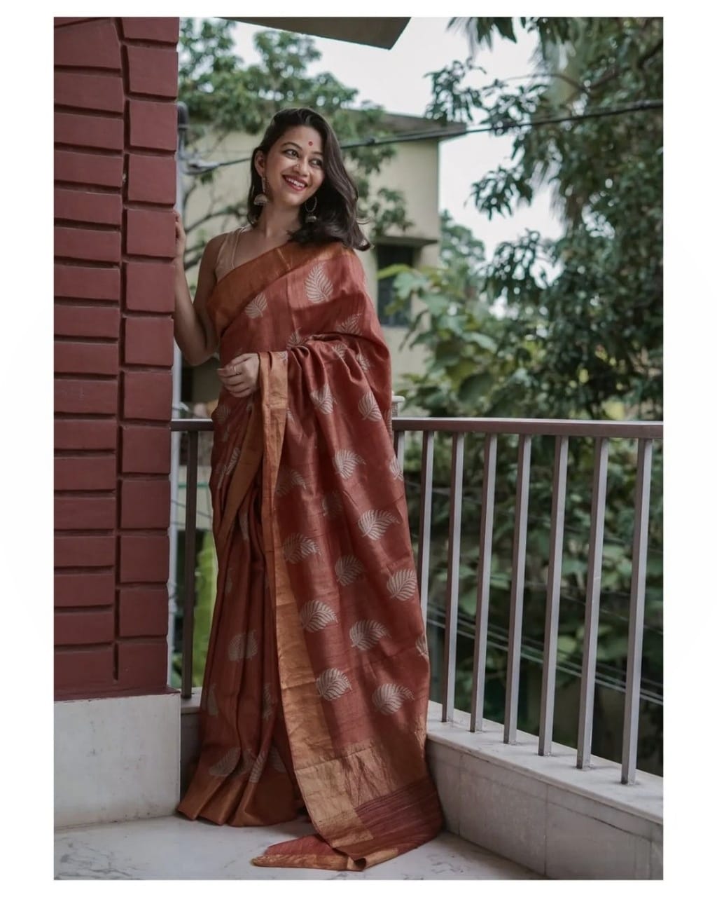 Teal Banarsi soft silk saree with copper jari leaf weaving and rich jacquard patterns.
