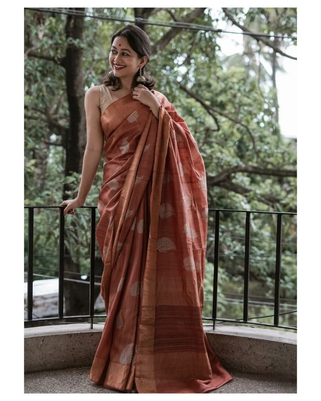 Banarsi soft silk saree with intricate copper jari leaf weaving and matching jacquard blouse.