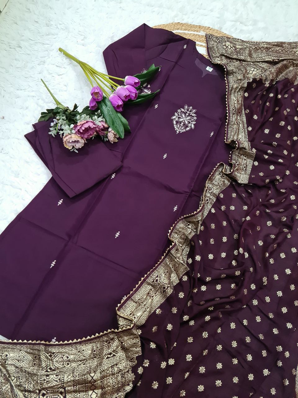 TRENDBUY ST-SWATI wine PV Chanderi kurti set, laid flat with floral arrangement, showing embroidery detail on kurti and borders of cotton jacquard dupatta.