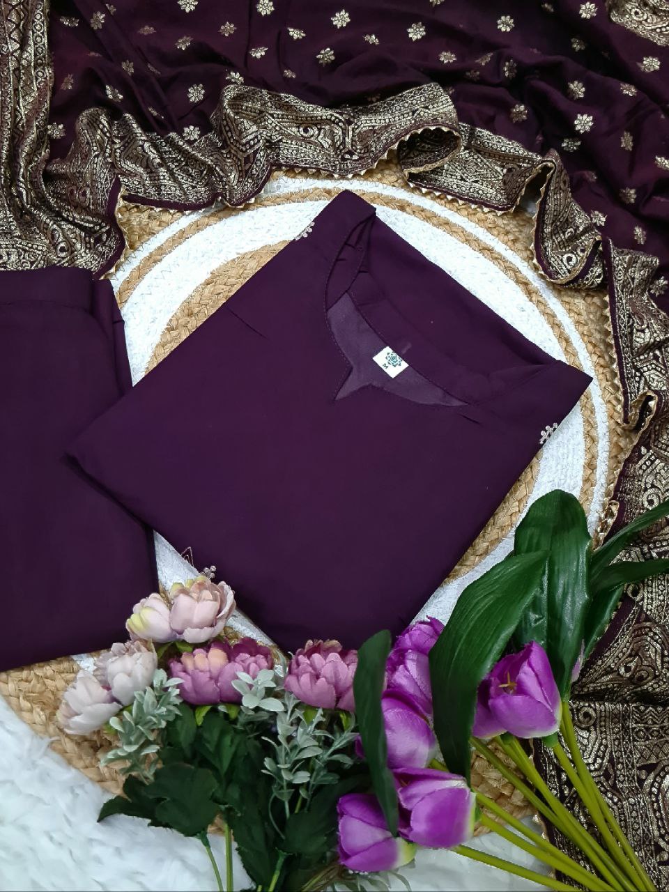 TRENDBUY ST-SWATI wine PV Chanderi kurti and folded cotton jacquard dupatta, presented on a jute mat with decorative flowers, highlighting the fabric and pattern.