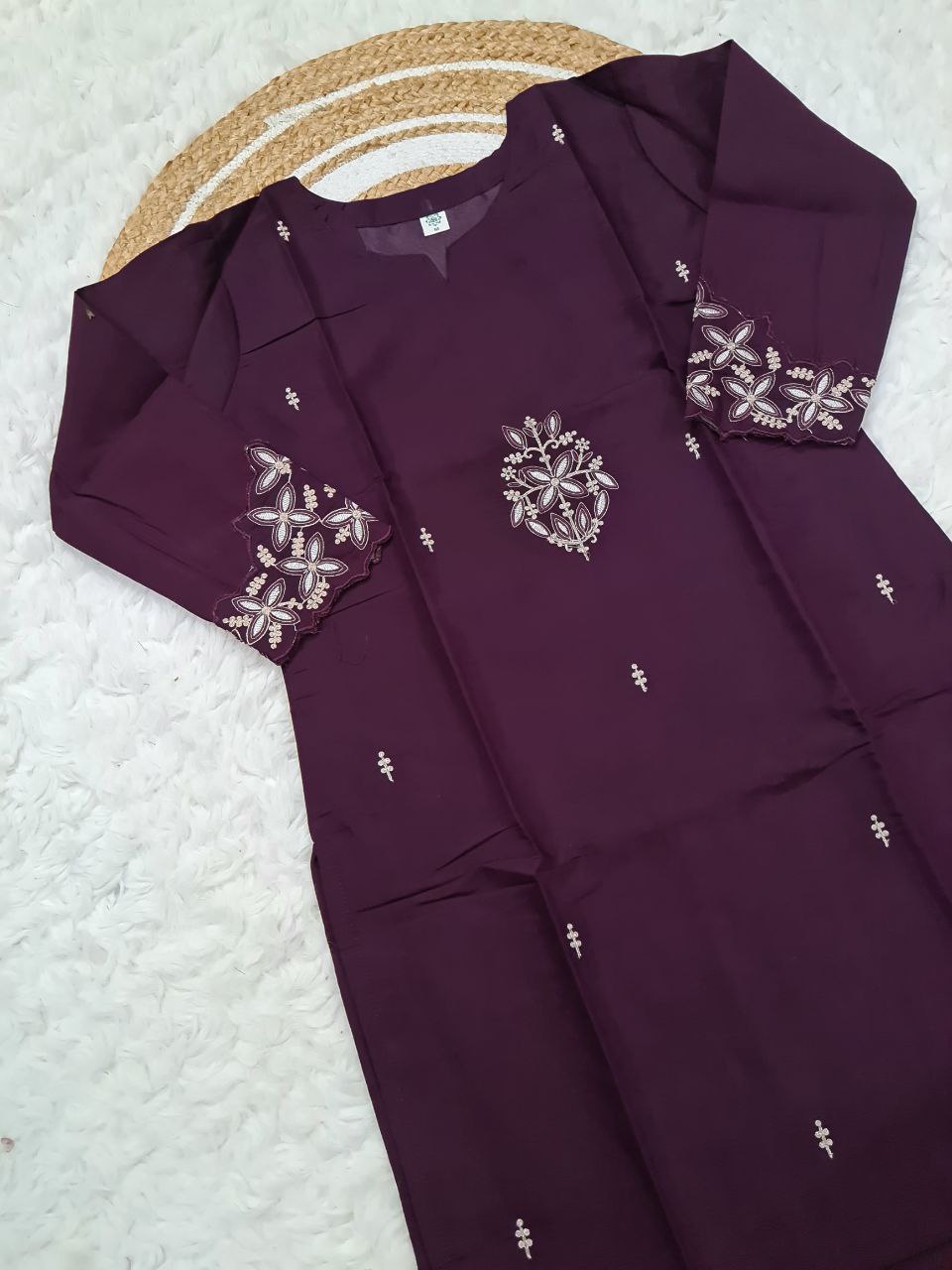 Unfolded TRENDBUY ST-SWATI wine PV Chanderi kurti showing intricate embroidery on the chest and sleeves, laid flat to display full detail.
