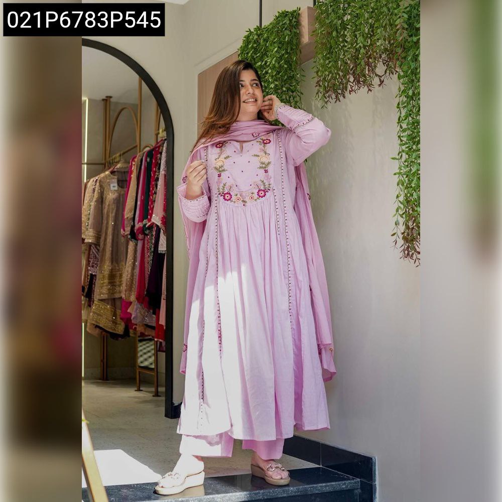 Full body shot of a woman in a lavender Chanderi silk embroidered kurta set, smiling and posing elegantly in a well-lit shop.