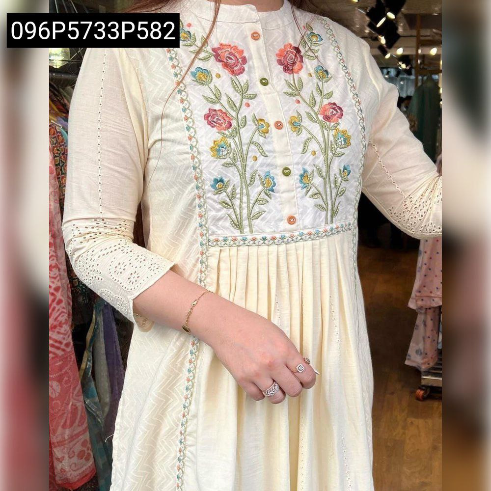 Model wearing TRENDBUY off-white cotton dobby shiffli kurti, showcasing the elegant self zikzak pattern, pleated detailing, and colorful floral embroidery on the bodice and sleeves.