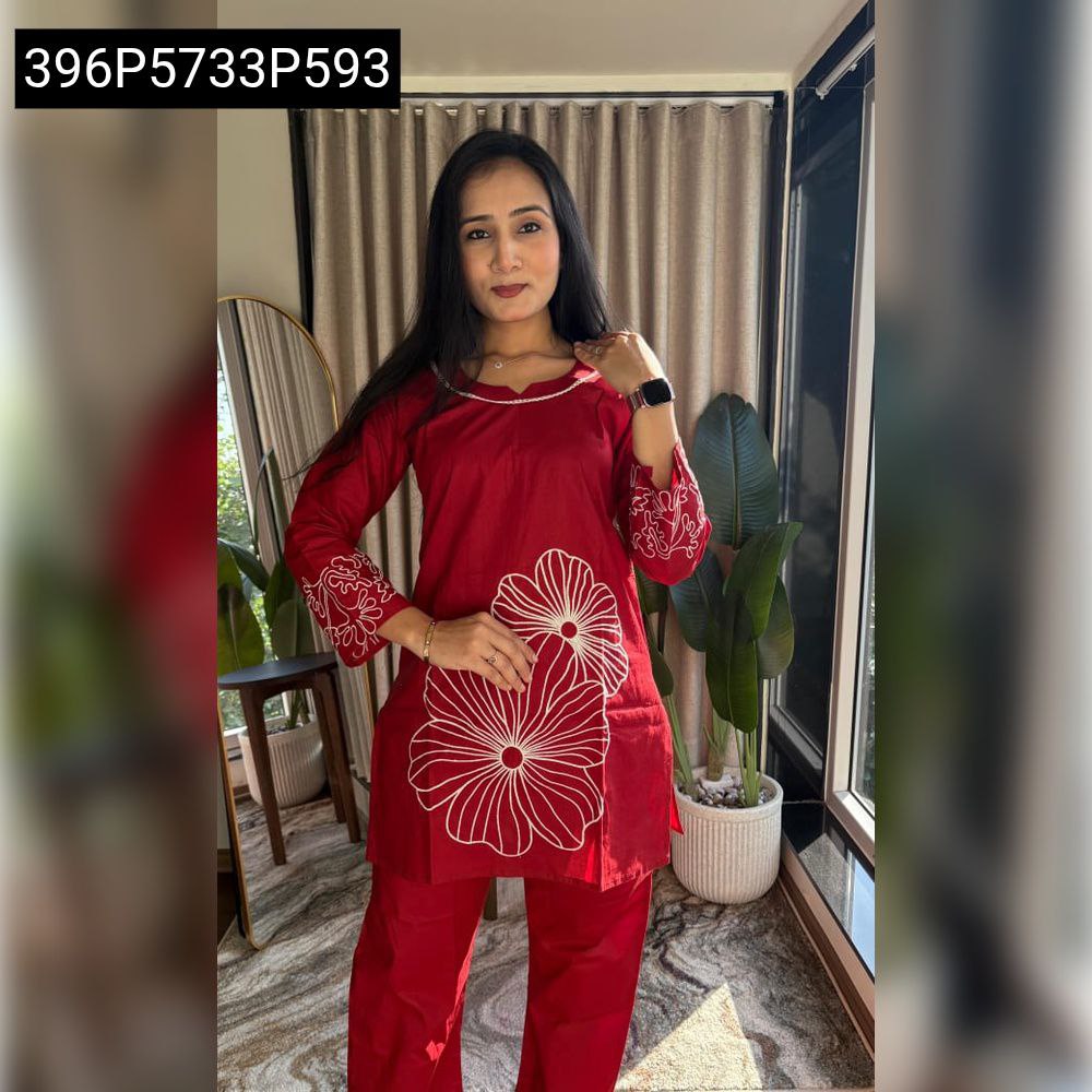 Model in a vibrant red TRENDBUY short top with plazo set, featuring white floral embroidery.