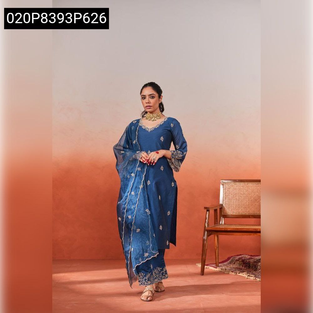 Elegant model wearing TRENDBUY Deep Blue Chanderi Silk embroidered kurti set with palazzo and dupatta, standing in a studio with a warm gradient background, exuding grace.