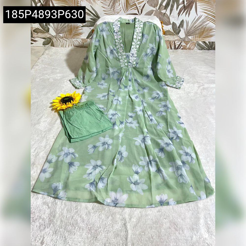 TRENDBUY green floral faux georgette kurta and matching cotton palazzo pants, laid flat on a white textured surface with a tropical leaf background and a yellow sunflower prop.