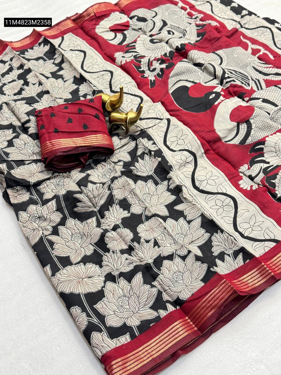 Red and black Mangalagiri silk saree featuring a Kalamkari peacock pallu and all-over lotus design, displayed with a matching blouse piece and brass elephants.