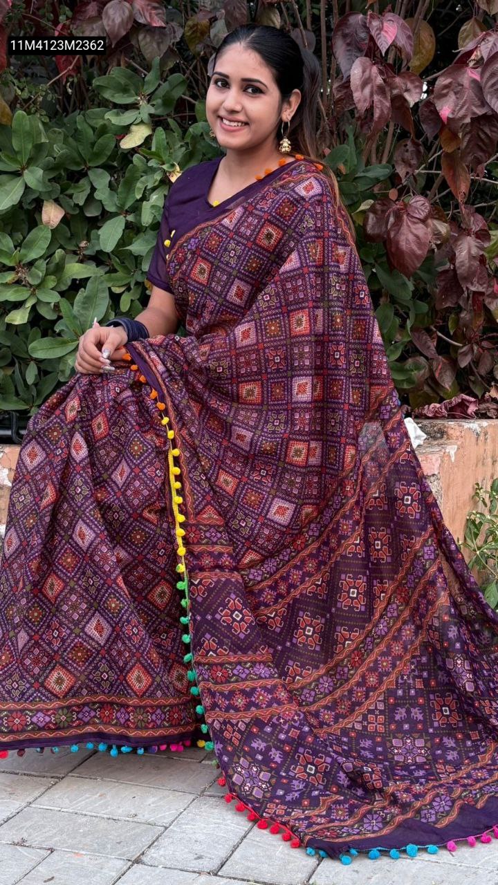 Close-up of a model's midsection and the lower drape of the TRENDBUY Purple Mul Mul Cotton Ikat Saree, highlighting the intricate print and colorful pom-poms.