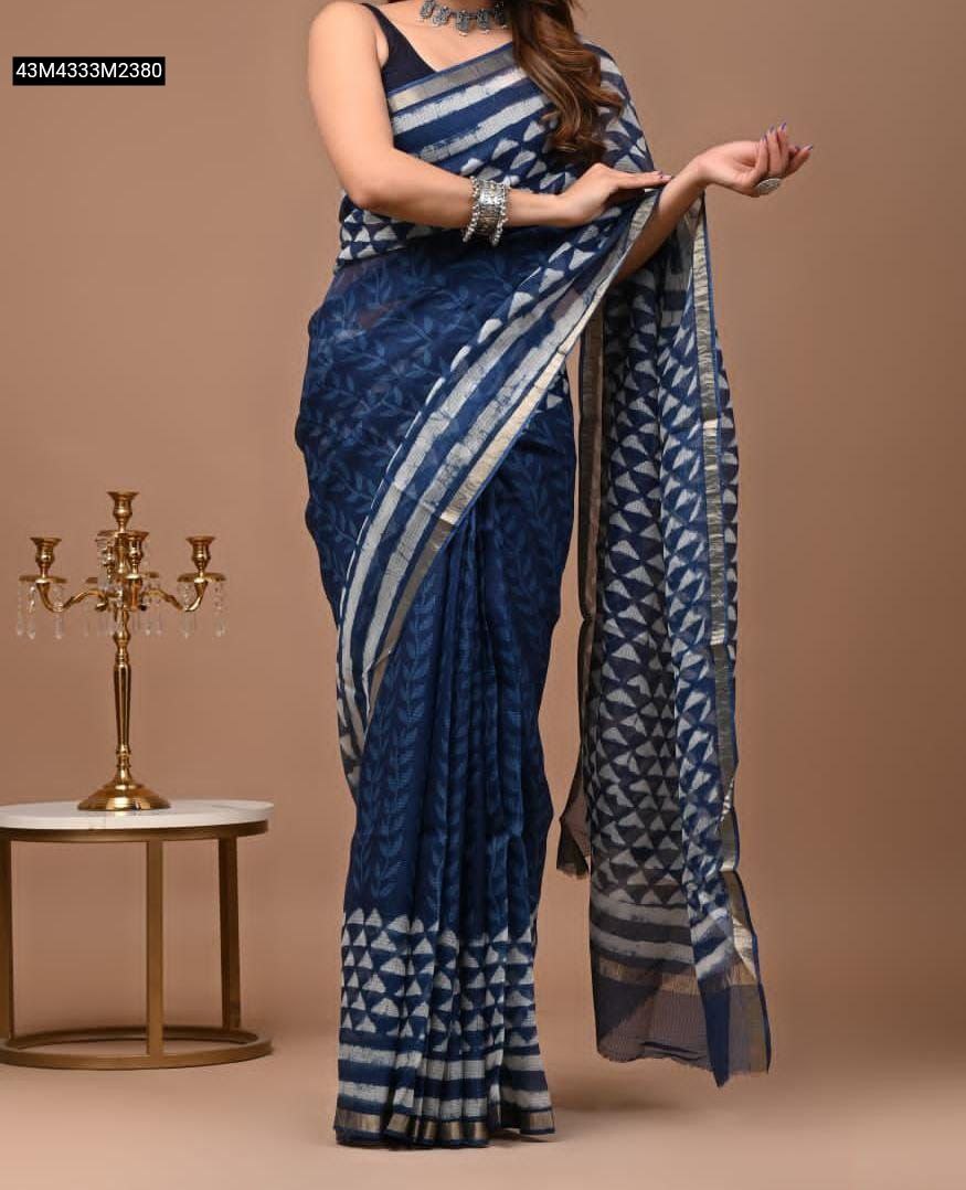 Model in TRENDBUY blue Super Kota Doriya saree with white leaf and geometric digital print, silver zari border, standing beside a gold candelabra.