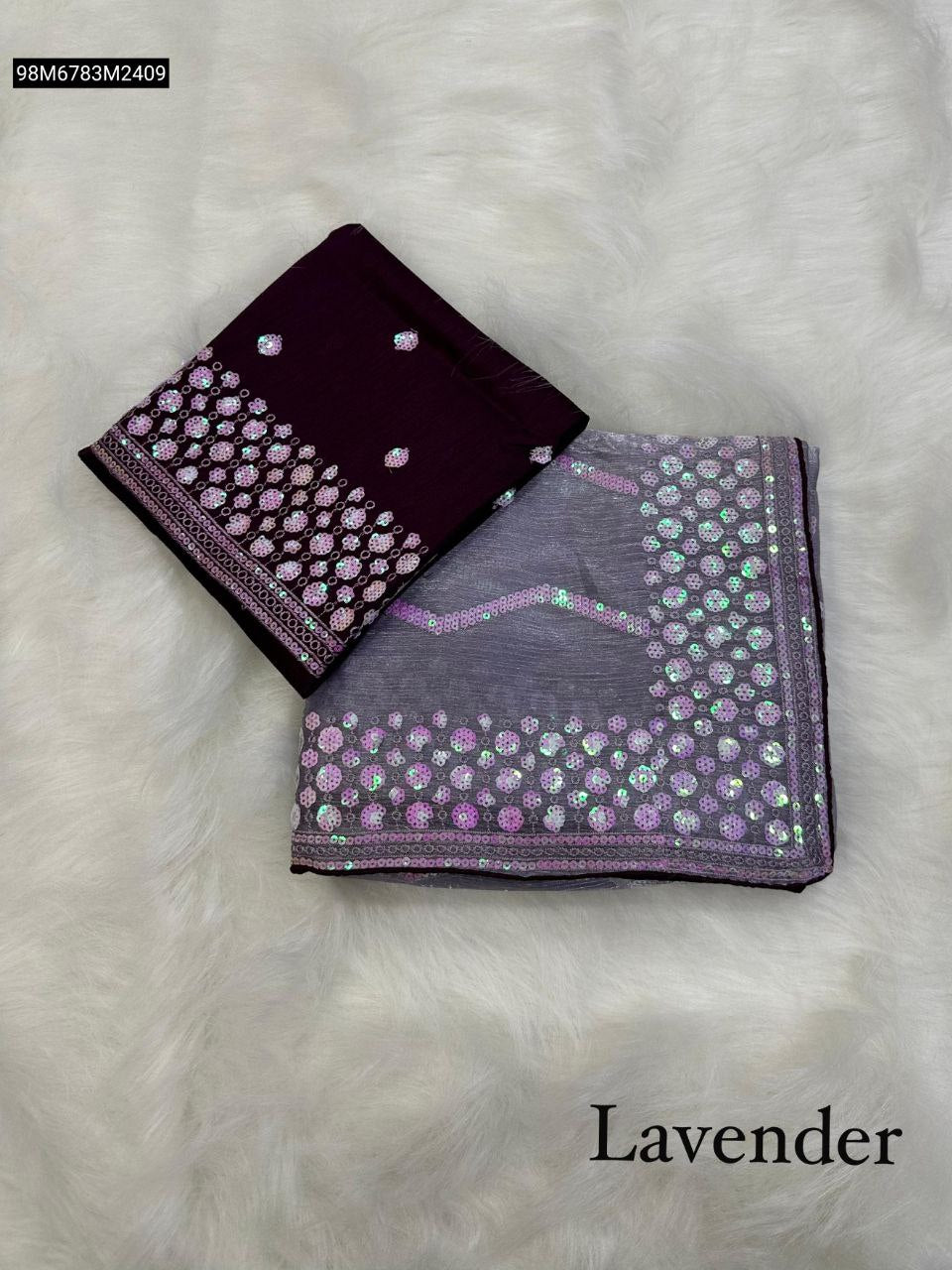 Folded TRENDBUY Lavender Zimmy Choo saree with C-Pallu 5MM sequence embroidery and matching dark purple Mono Diamond Silk blouse, displayed on a white furry background.