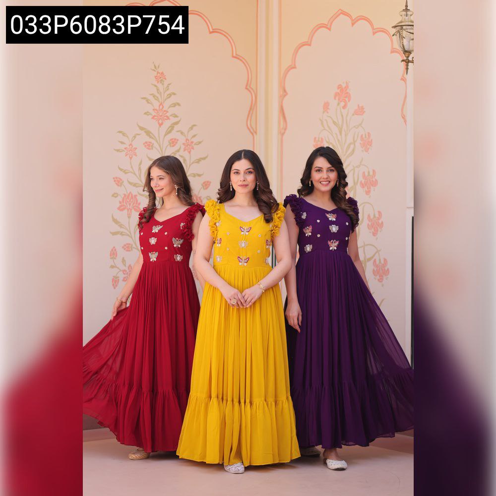 Three women posing in sequined embroidered faux blooming gowns in maroon, yellow, and purple colors.
