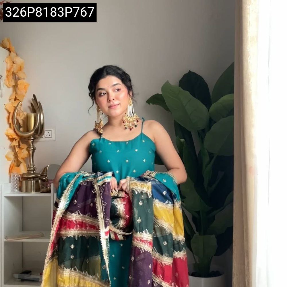 Model posing with teal embroidered top, maroon sharara, and multi-color digital print dupatta, embodying festive elegance.