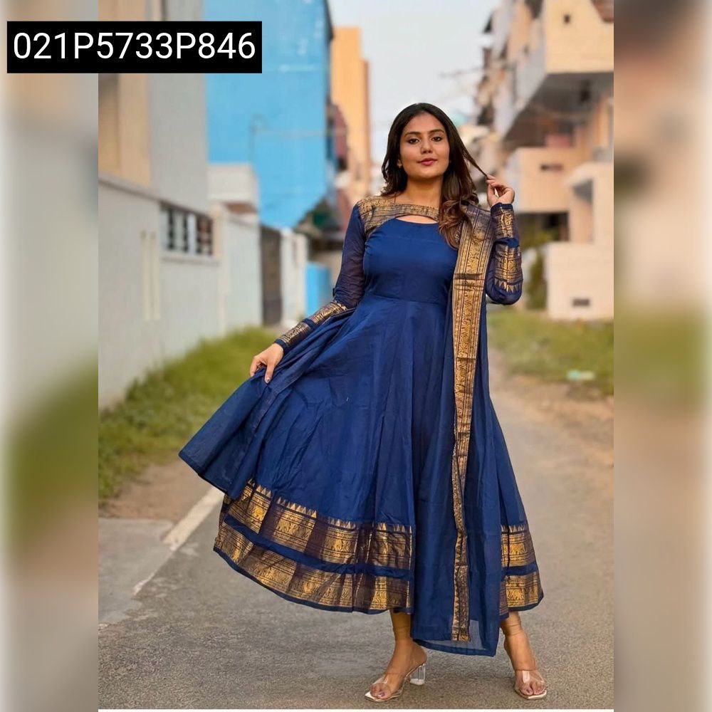 Model posing in a royal blue Jacquard Silk Cotton Anarkali Gown with gold Jari weaving, perfect for parties.