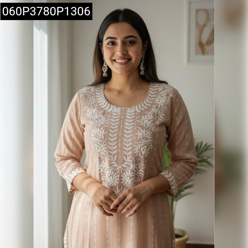 Smiling woman posing in light peach embroidered khadi cotton kurti, front view