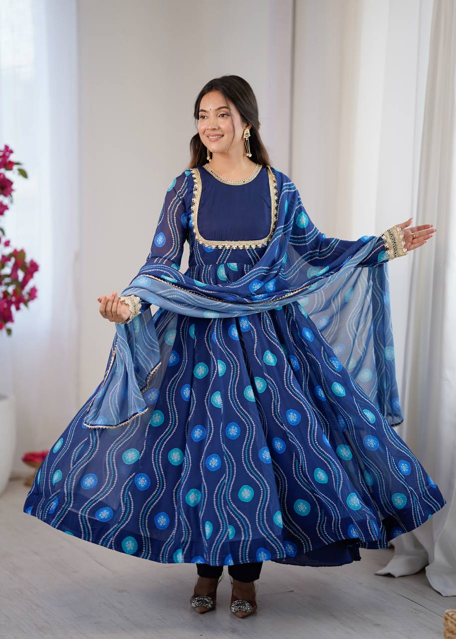 Woman posing elegantly in a navy blue Bandhani print Kali cut Anarkali gown, showcasing the full flair.